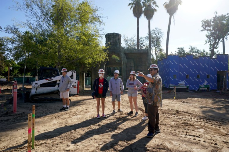 Dr. W. Saam Noonsuk points as students look an at the construction site.