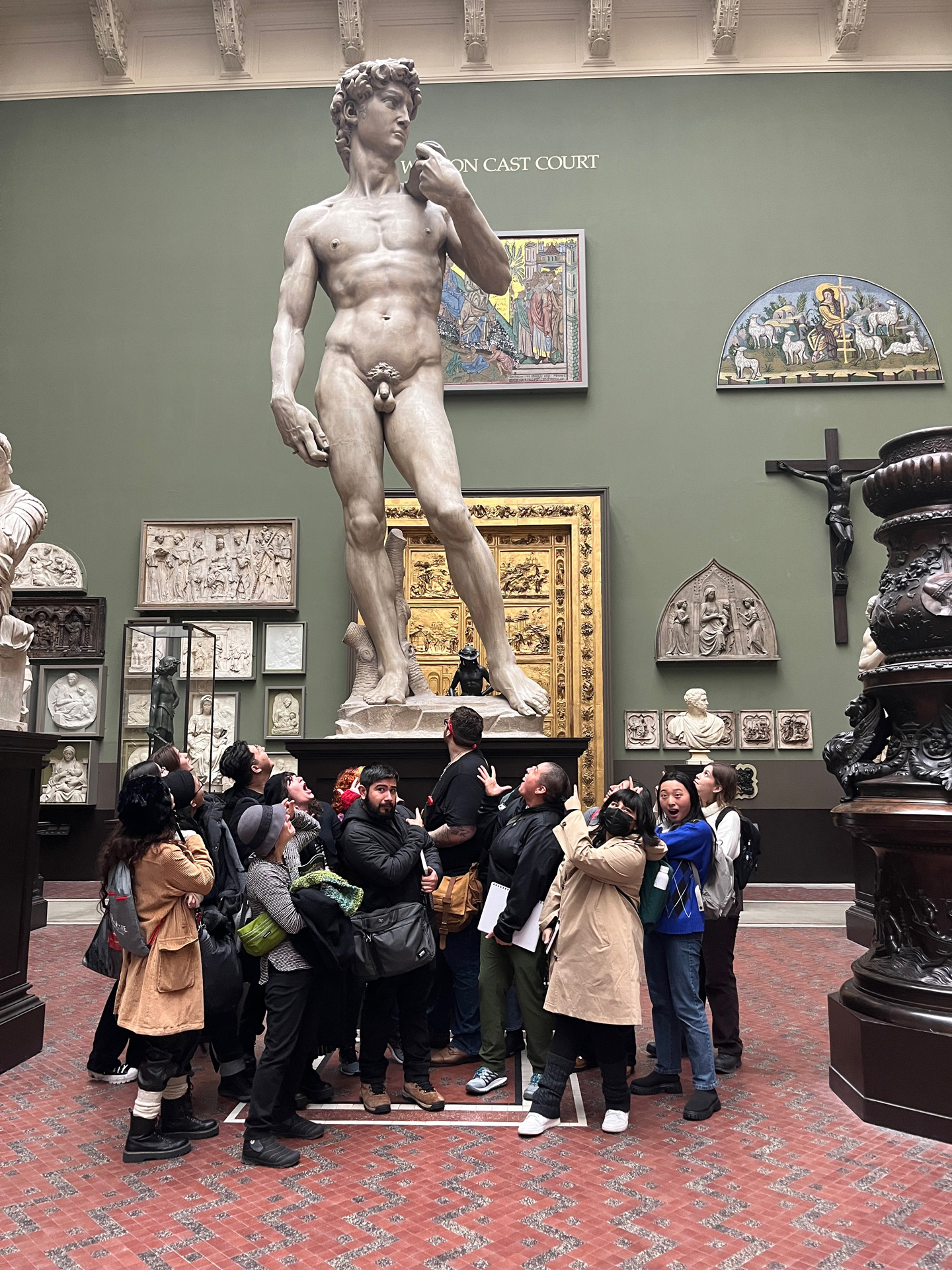 Students look at a casting of Michelangelo's sculpture of David in the he Weston Cast Court of the Victoria and Albert Museum.