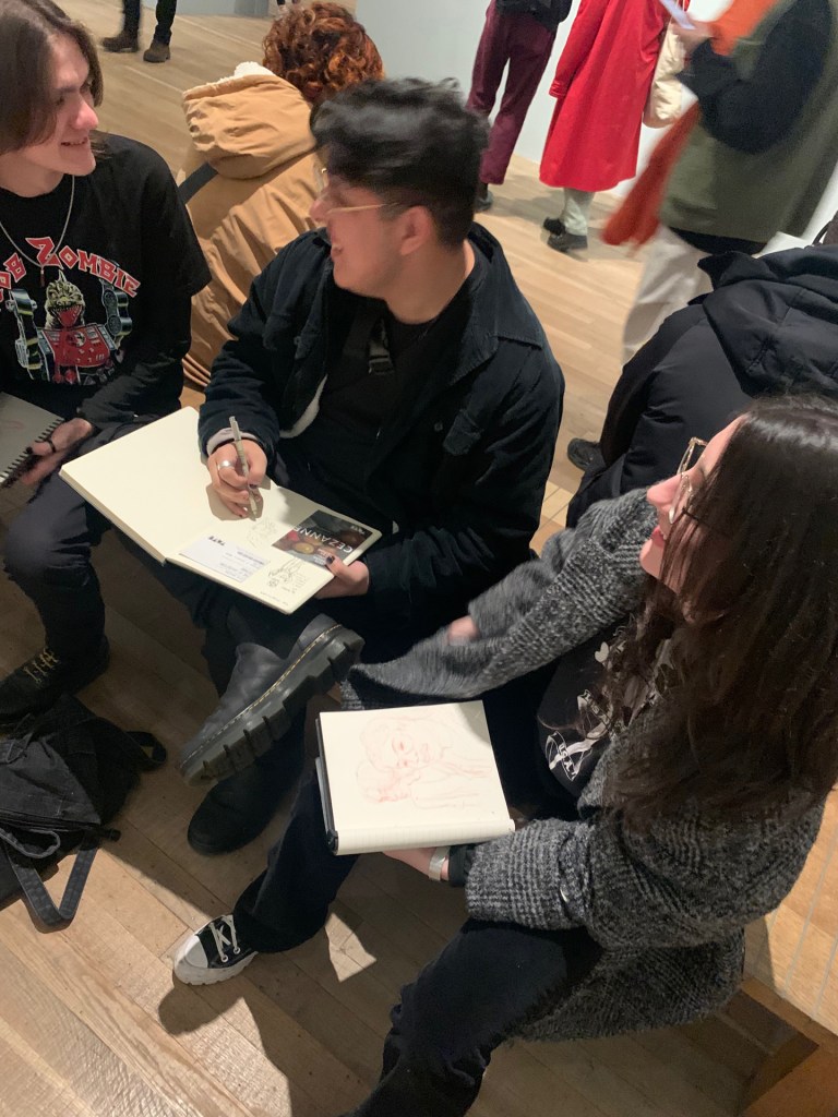 Students sketch in an art museum.