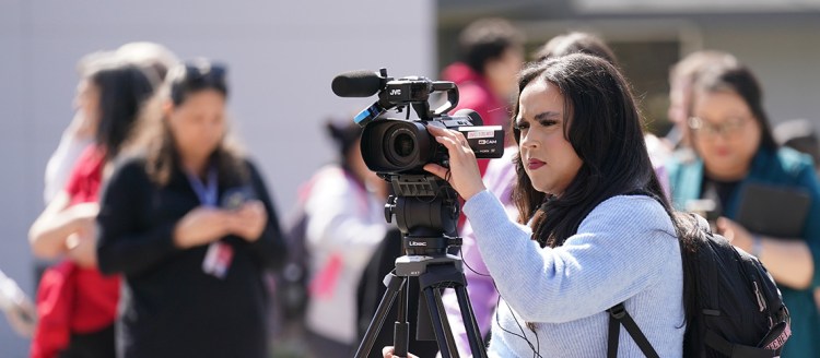 Fresno State Focus reporter Viviana Hinojos with a camera.