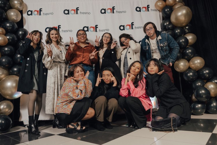 Fresno State graphic design students pose for a group shot at the local ADDY awards in Downtown Fresno.