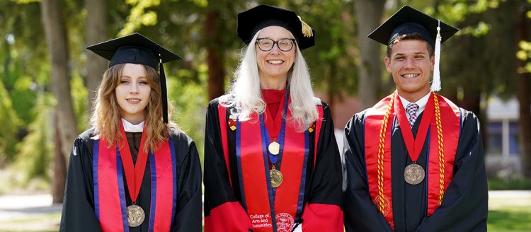 Graduate Dean's Medalist Mialise Carney, Dean Honora Chapman and Undergraduate Dean's Medalist Lucca Lorenzi in full regalia on the Fresno State campus.