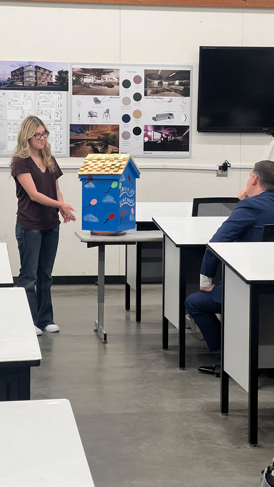 Student presents their little library project.