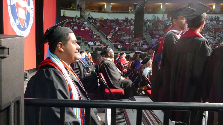 Maurissio Rodriguez site at a keyboard as he prepares to perform "We Are the Champions" for the recessional.