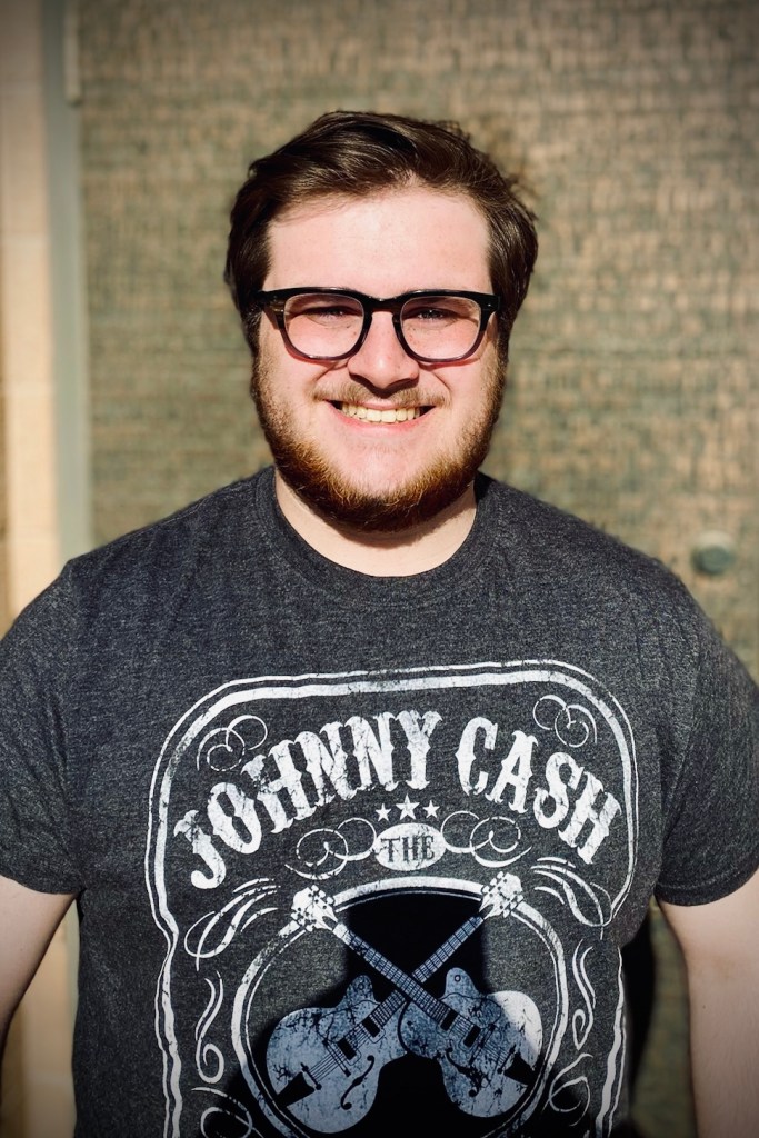 Mitchel Statler will be pursuing his Master of Fine Arts in Technical Direction at the University of Nevada, Las Vegas. He is wearing a Johnny Cash T-Shirt.