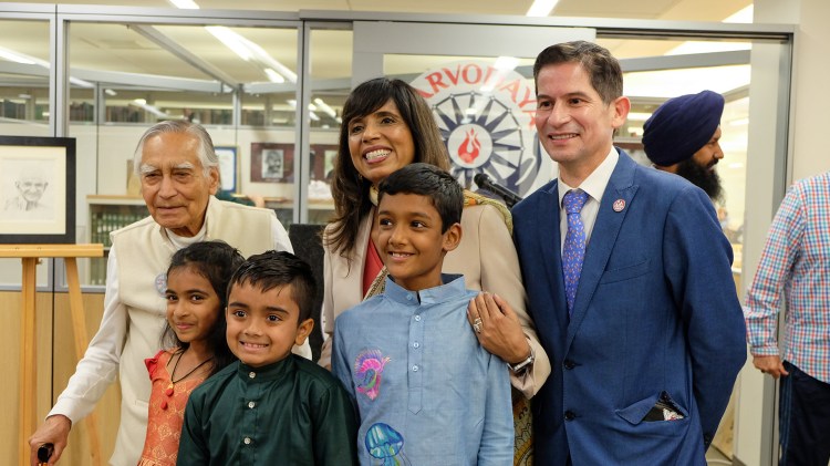Three young students from with the Chinmaya Mission Balvihar Fresno pose with Dr. Kapoor, Dr. Howard and President Jimenez-Sandoval in front of the M.K. Gandhi Center