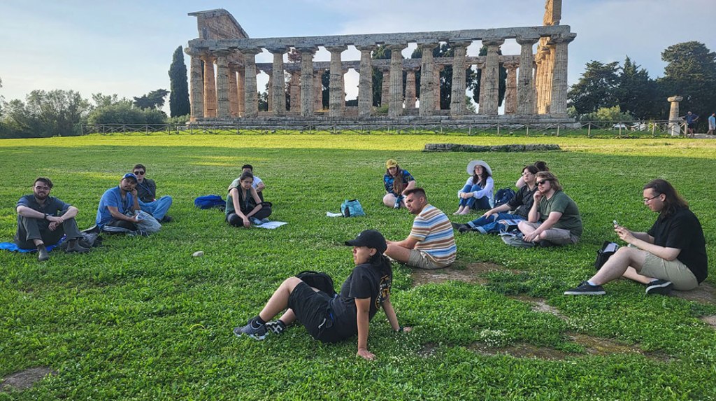 Fresno State students on the grass next to the Temple of Athena.