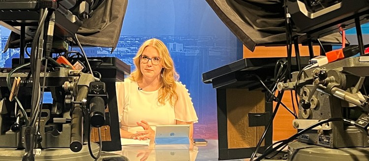 Student Emily Crabtree on the anchor desk during Fresno State Focus with two TV cameras facing her.