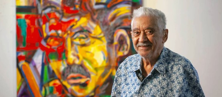 Ernesto "Ernie" Palomino stands in front of his self portrait. Photo courtesy of the La Brocha Art Foundation.