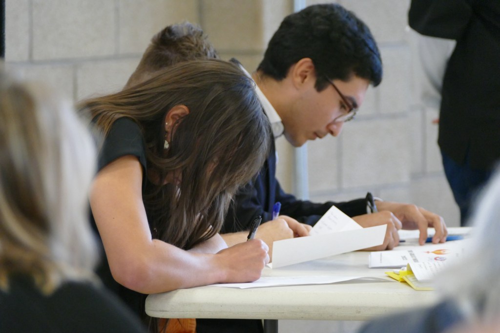 The Fresno State team vigorously takes notes durning the debate.