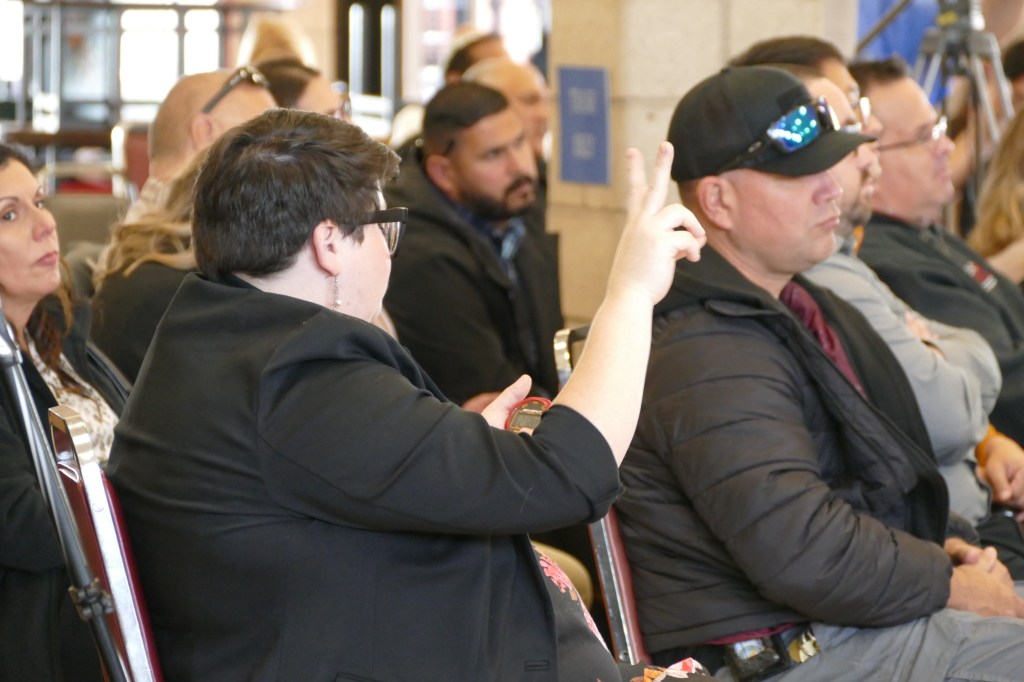 Fresno State debate coach Natalie Meaney Cavallero keeps time during the debate.