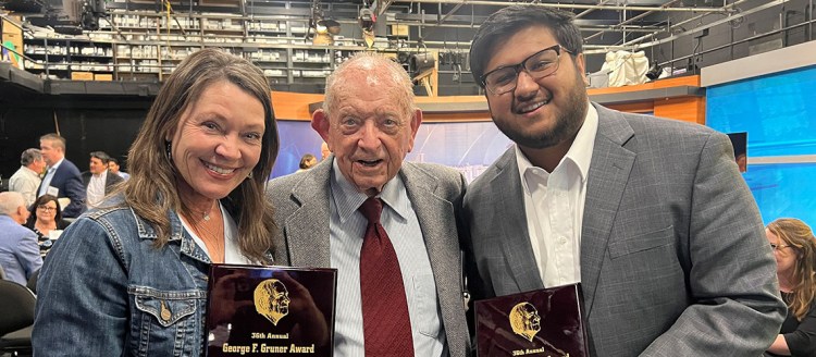 Prize winners of the George F. Gruner Award, Omar Shaikh Rashad and Lois Henry, pose with George F. Gruner.