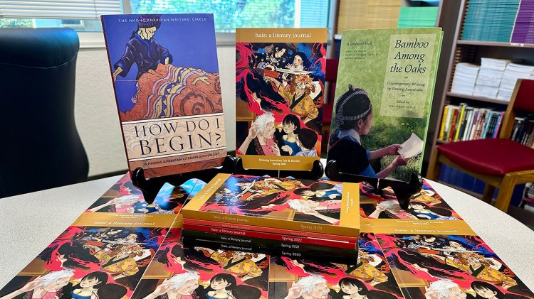 The new fifth issue of hais: a literary journal (2024) sits alongside two canonical anthologies of Hmong American literature, “How Do I Begin?” (2011) and “Bamboo Among the Oaks” (2002).
