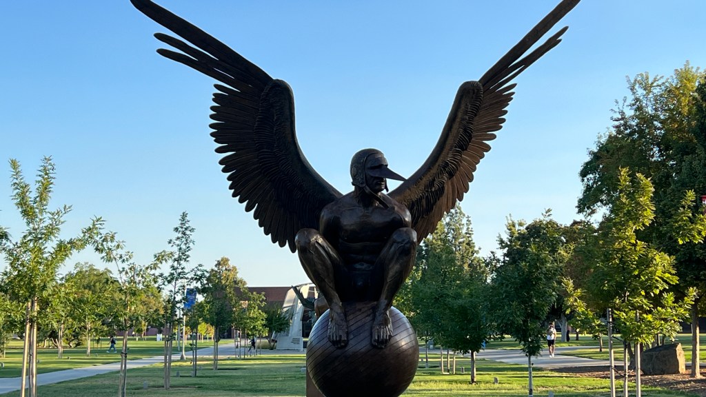 Bernardo Oriental - 2006 | 7.8 x 8.5 x 3.2 ft - Part of a series of winged creatures, this sculpture possesses unique characteristics, such as the position of the body, as if captured at the moment it is about to stand and take flight. Upon his head is an aviator's hat; the dream of flying materialized into the human condition.