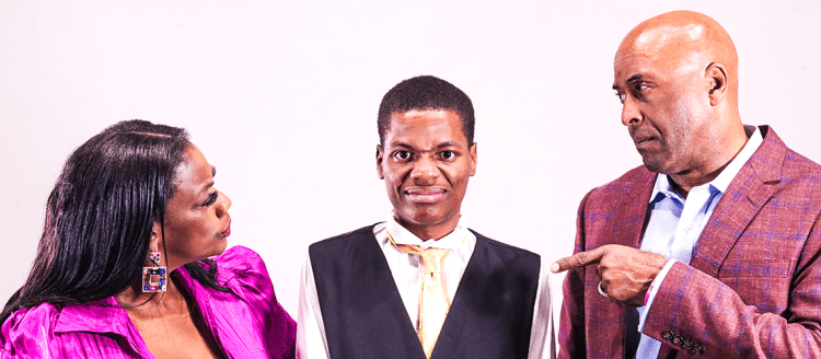 A mother in a pink dress and a father in a blazer look and point disapprovingly at their African-American son in the center of the photo.