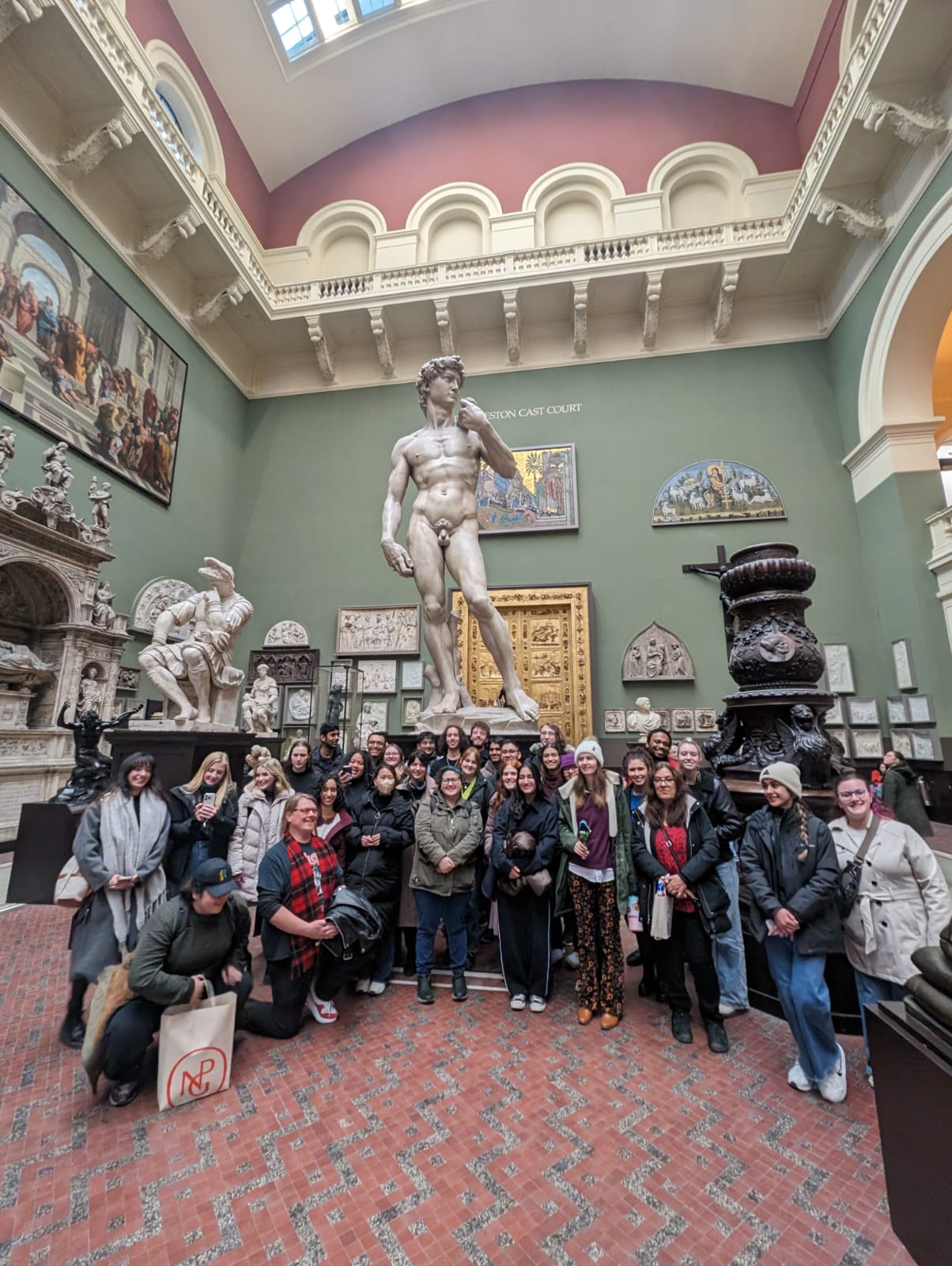 Fresno State students in front of a Michelangelo David replica in the Victoria and Albert Museum in London.
