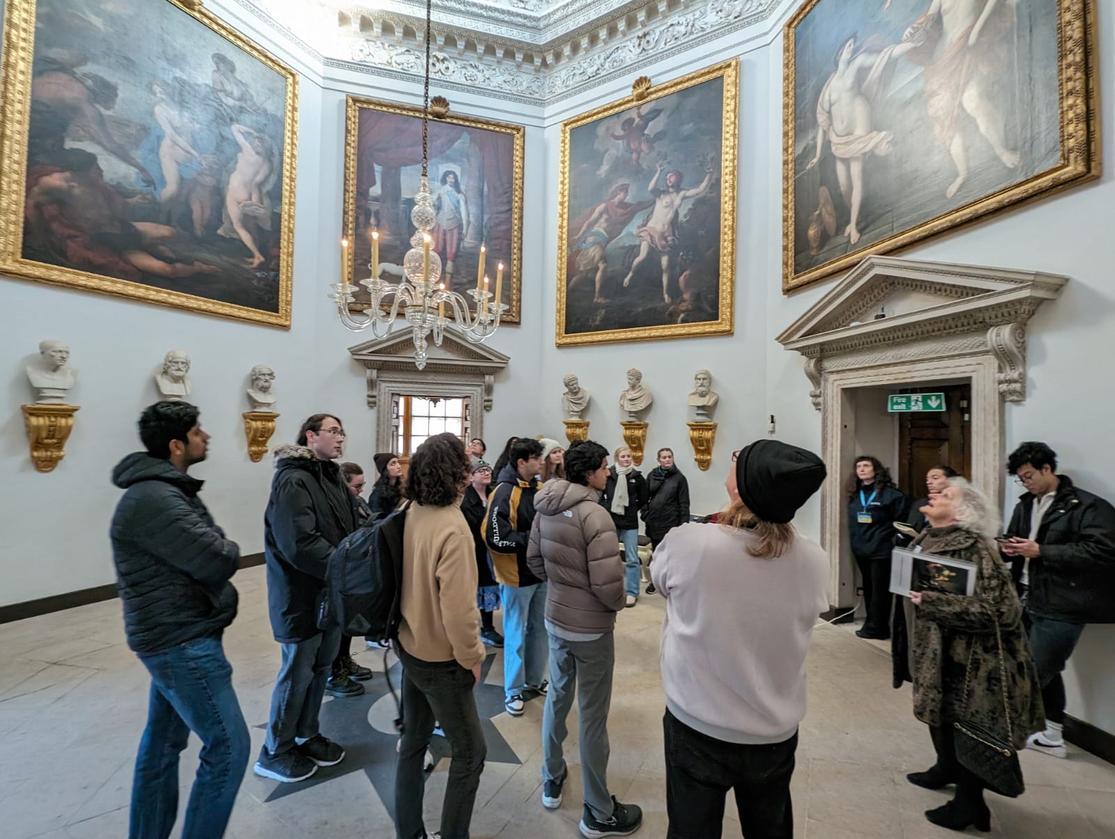 Fresno State students look up at a fine art collection inside Chiswich House in London.