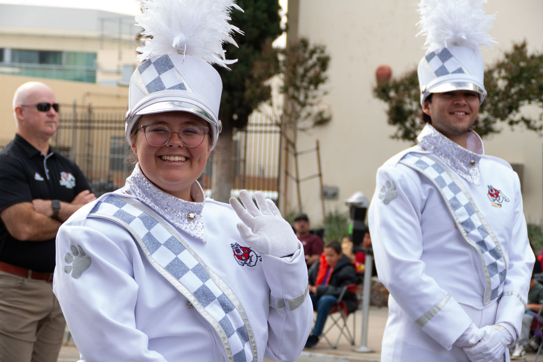 Drum Major Danielle Densmore waves ahead of the Veterans Day Parade in Downtown Fresno.