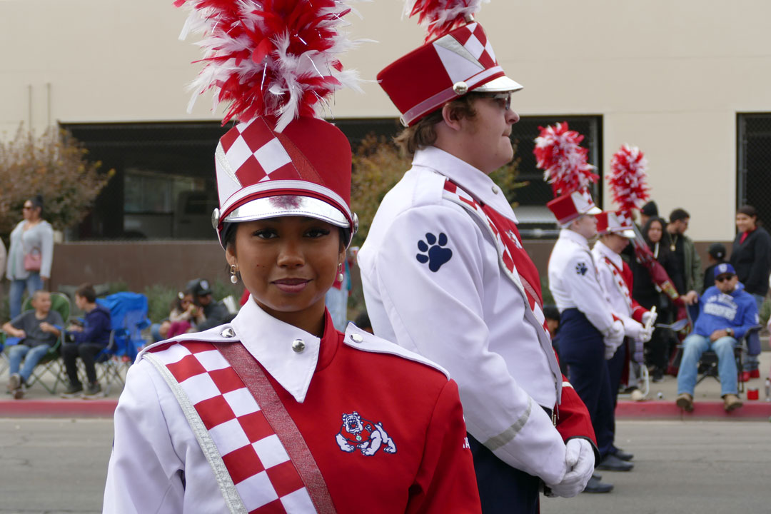 A Piccolo player in the Bulldog Marching Band turns for a photo.