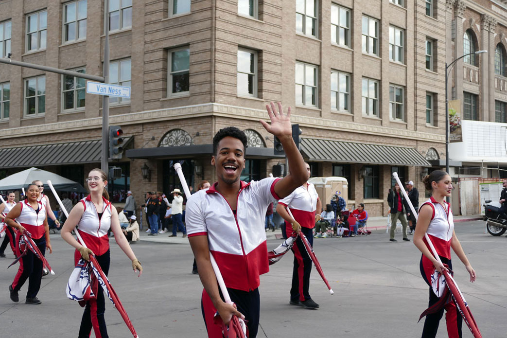 Caleb Benson, color guard, wave during the 2024 Veterans Day Parade.