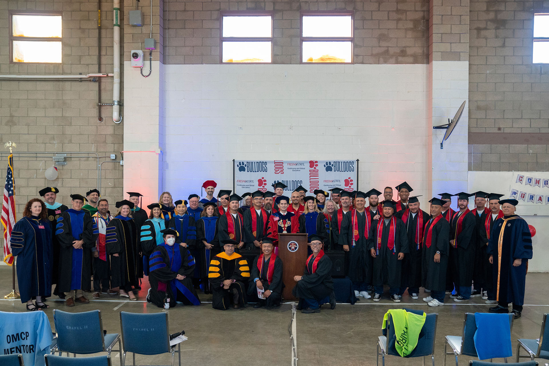 A group shot of graduates, faculty and administrators following commencement.
