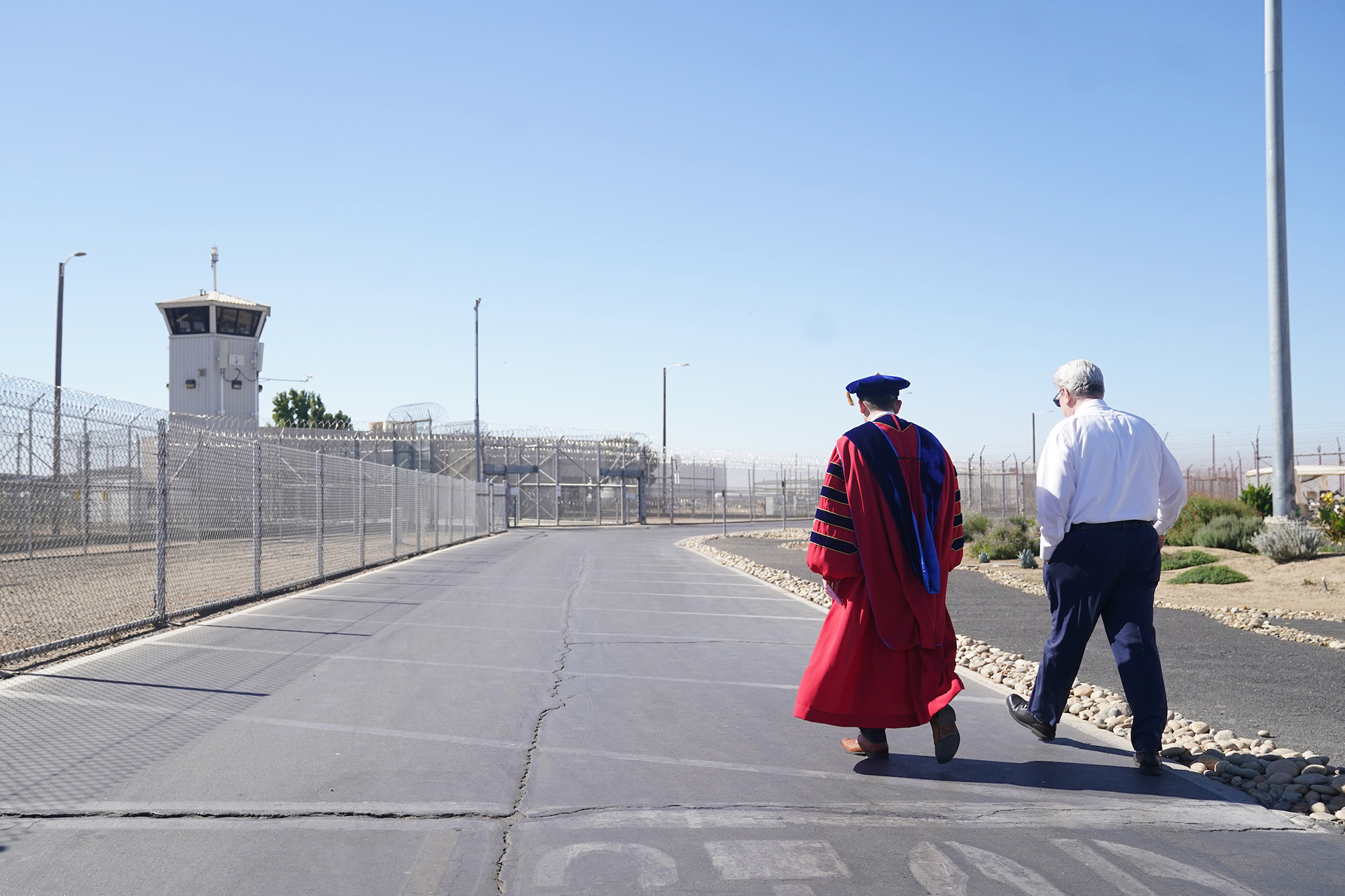 Fresno State President Saul Saúl Jiménez-Sandoval walks inside Valley State Prison.