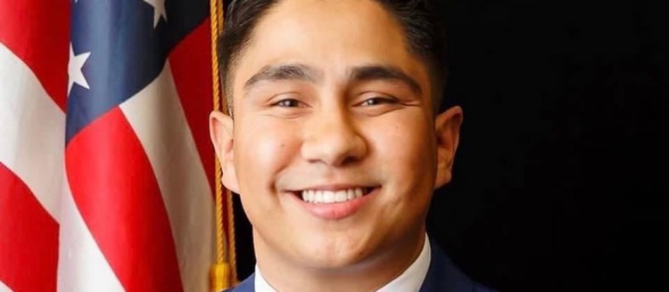 Salvador Solorio-Ruiz headshot next to an American Flag