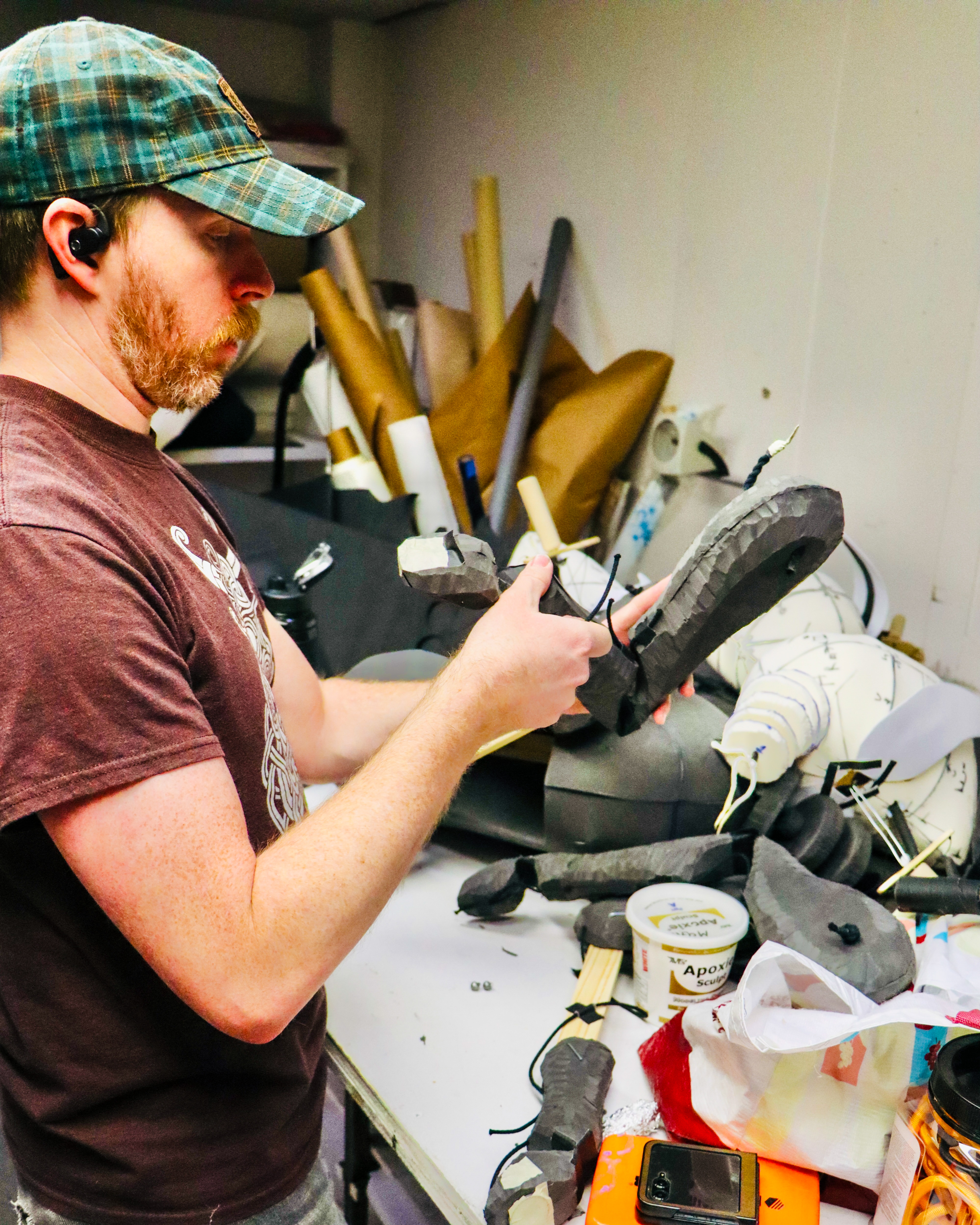 Alumnus Matt McGee making puppets at his workbench.