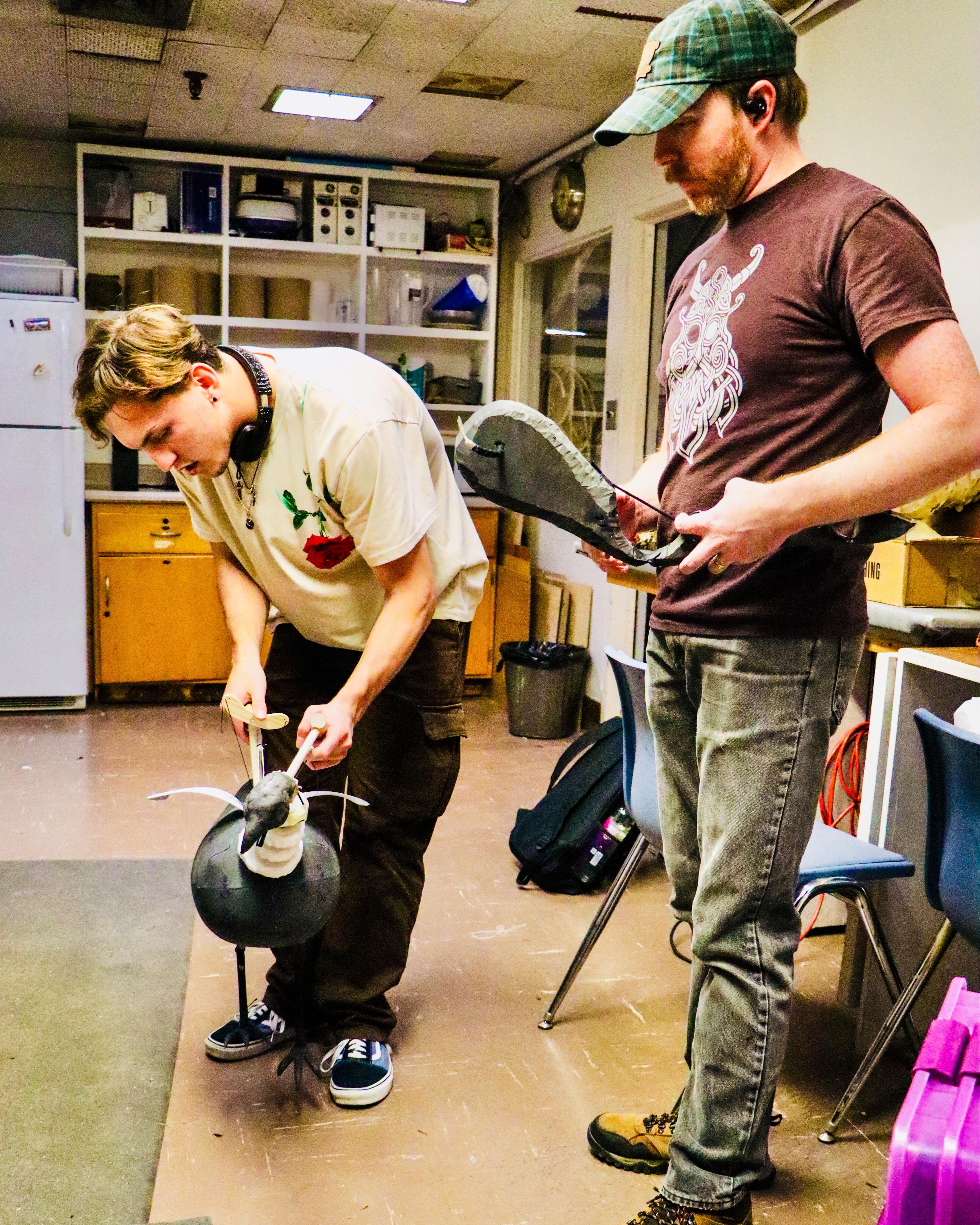 Student and Matt McGee practice with a chicken puppet.