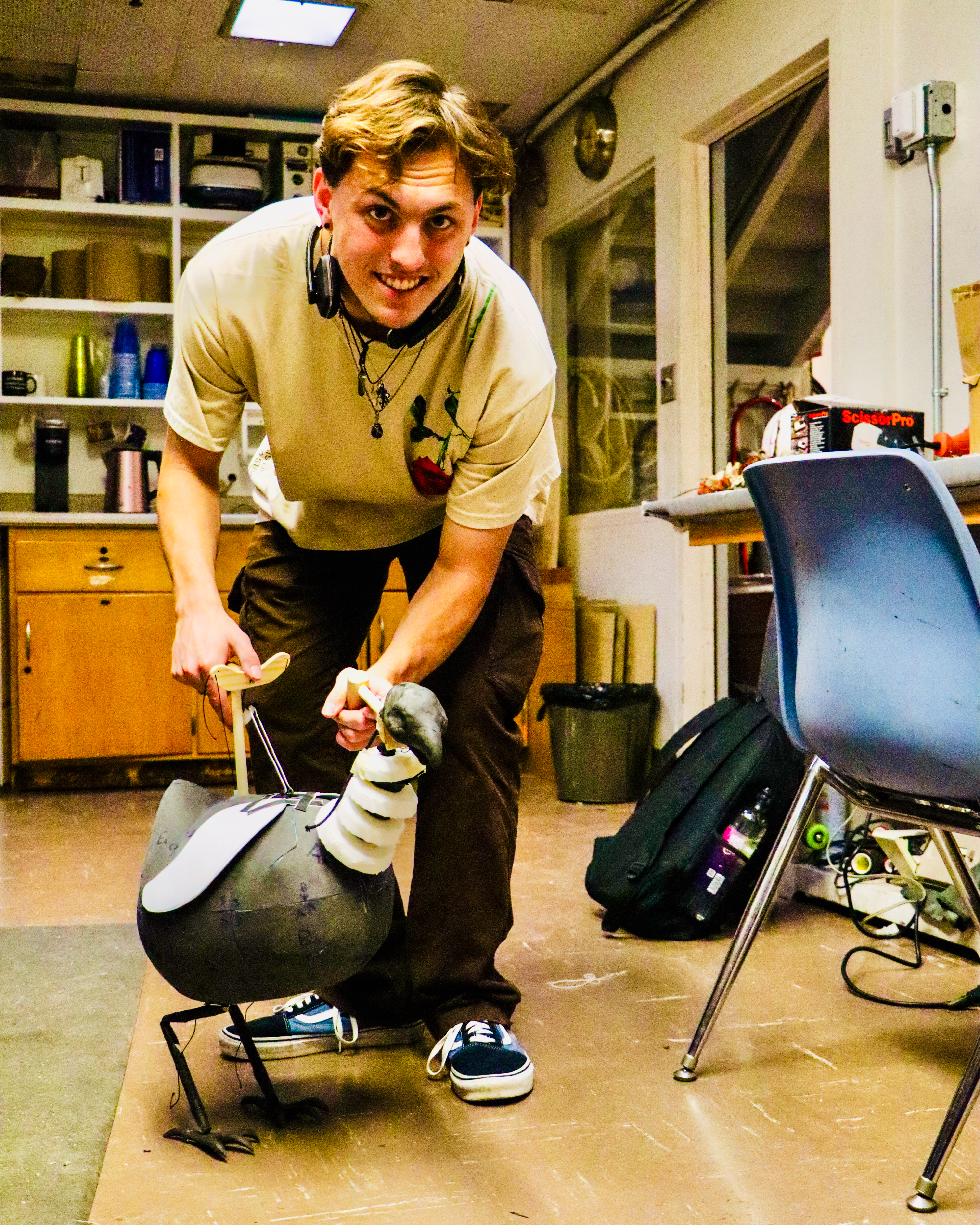 Student practices with a chicken puppet.