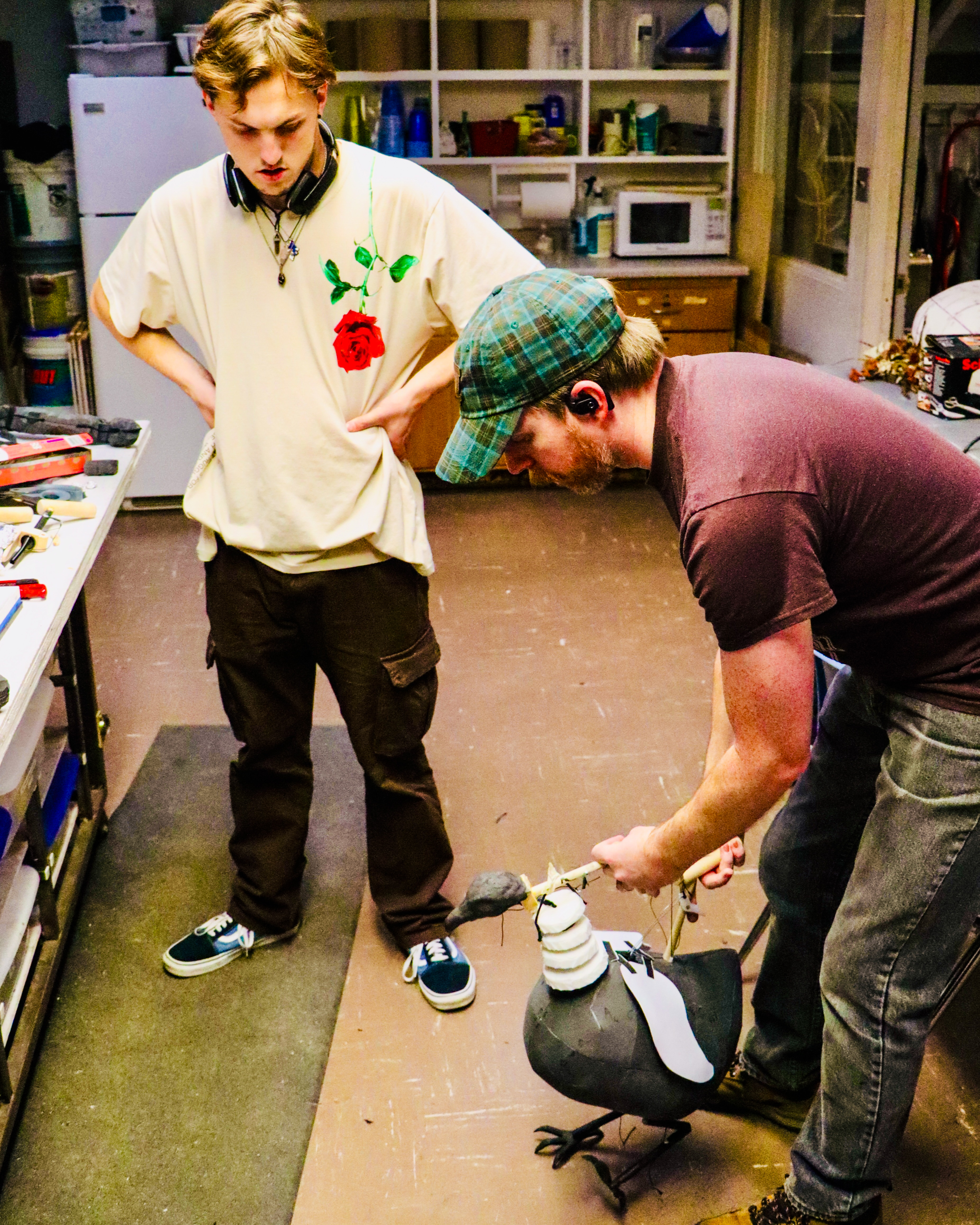 Student and Matt McGee practice with a chicken puppet.