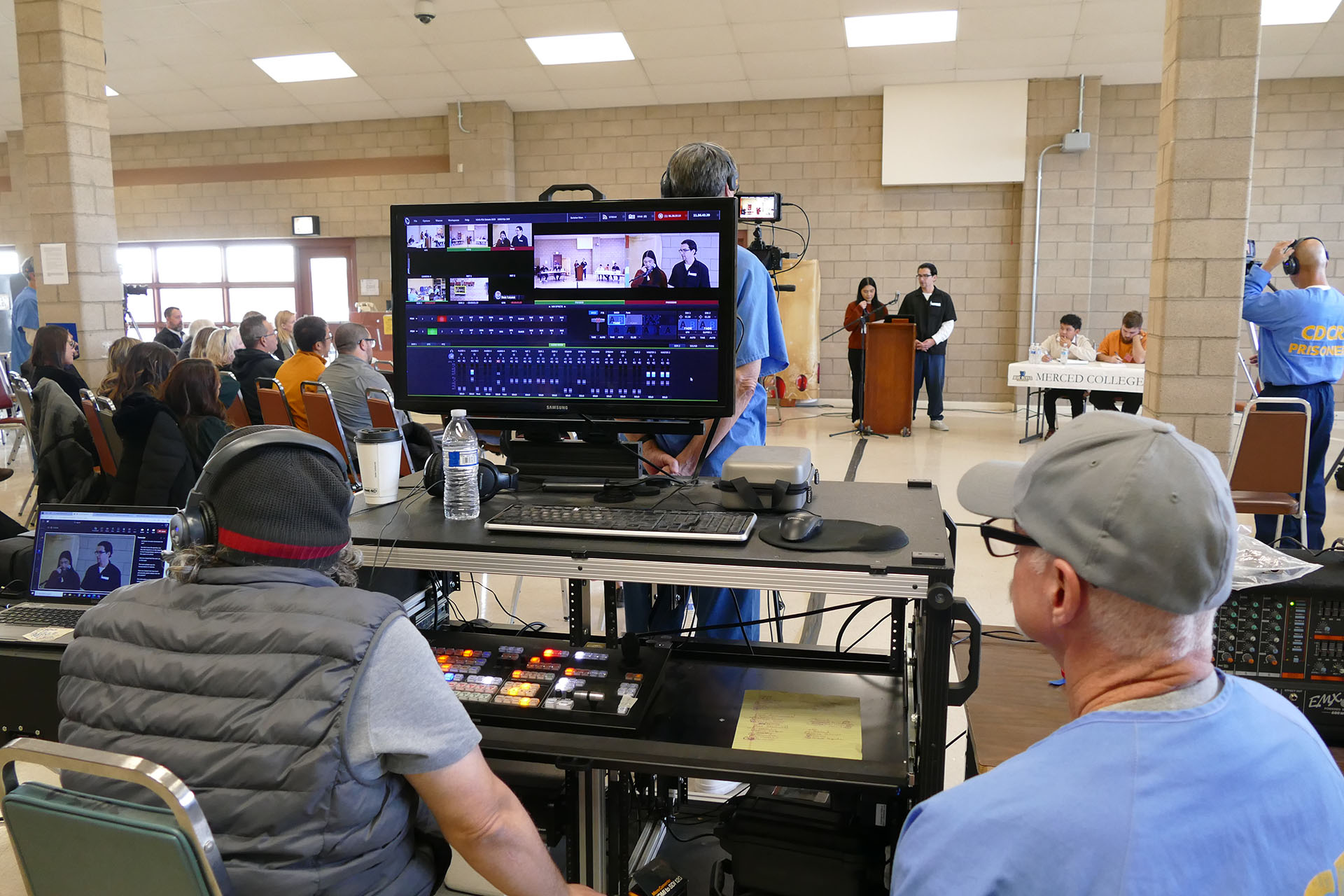 Incarcerated men run the video equipment during the debate at Valley State Prison.