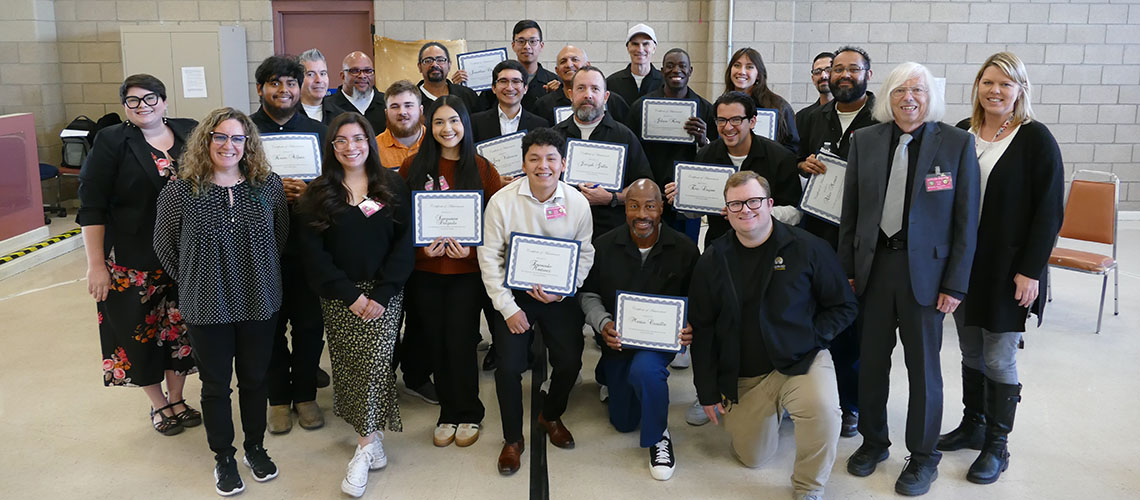 Fresno State Barking Bulldogs and Valley State Prison debate teams show off certificates.