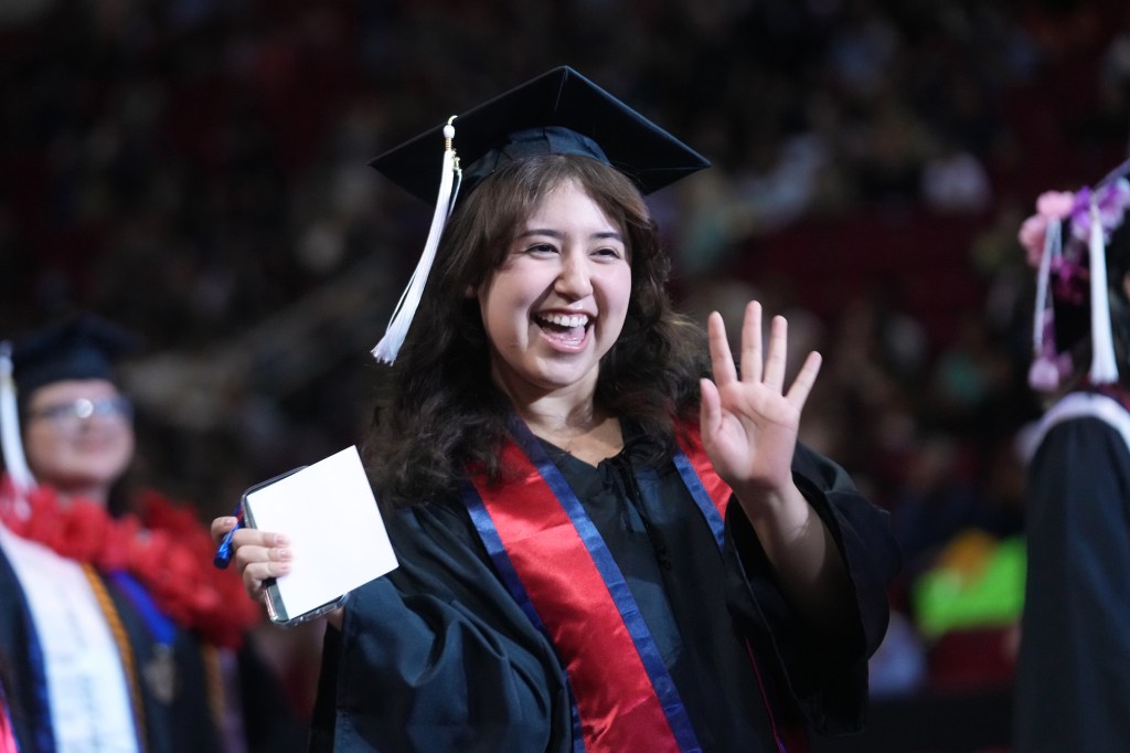 Grad smiles and waves.
