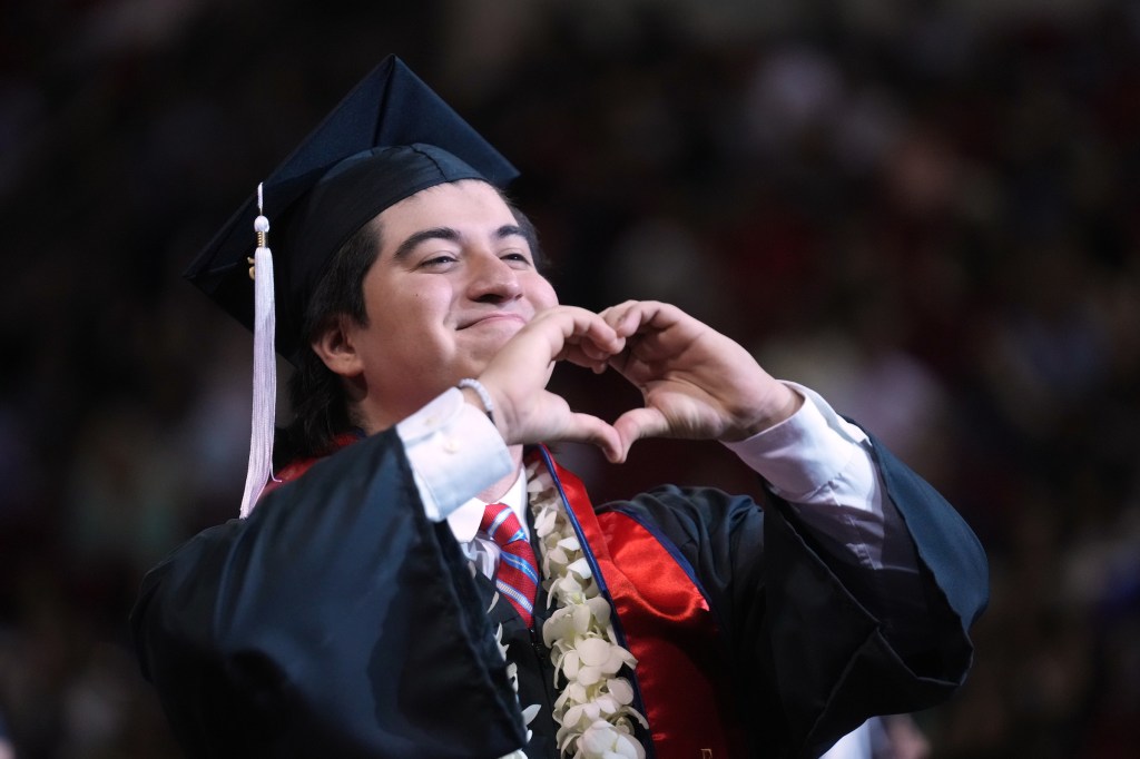 Grad makes a heard with his two hands.