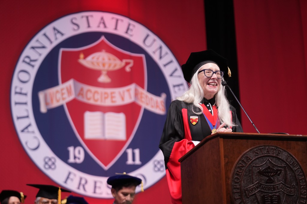 Dr. Honora Chapman, Dean of the College of Arts and Humanities, at the podium.
