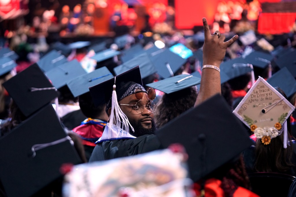 Grad throughs hang loose side to the crowd.