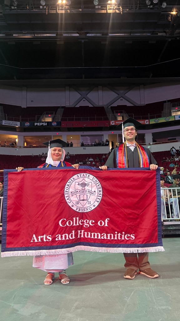 Standard Bearers Davian Barba, B.A. in music, and Seja Zaghmouri, B.A. in philosophy, led the procession of students onto the floor of the Save Mart Center