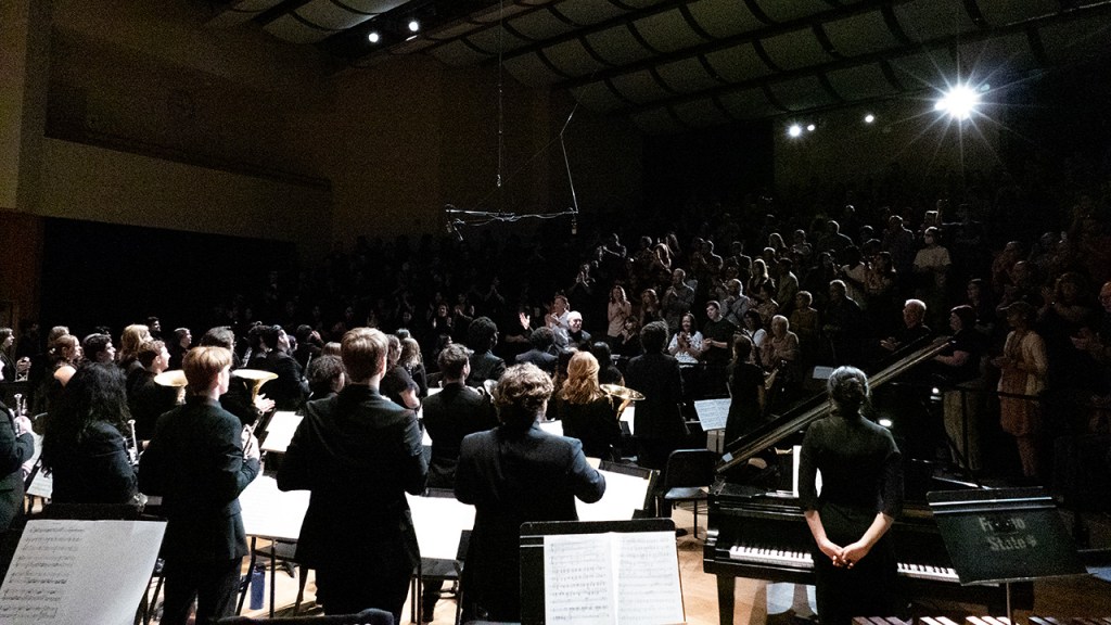 The orchestra and the audience rise in a standing ovation at the conclusion of Dr. Gary Gilroy's last concert.