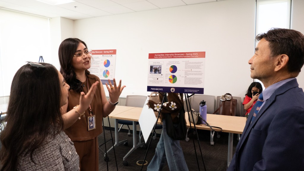 Dr. Xuanning Fu, provost and vice president for Academic Affairs at Fresno State talks with a Parlier Unified School District employee and Emily Avila, Fresno State student, at the Humanities Internship Showcase.