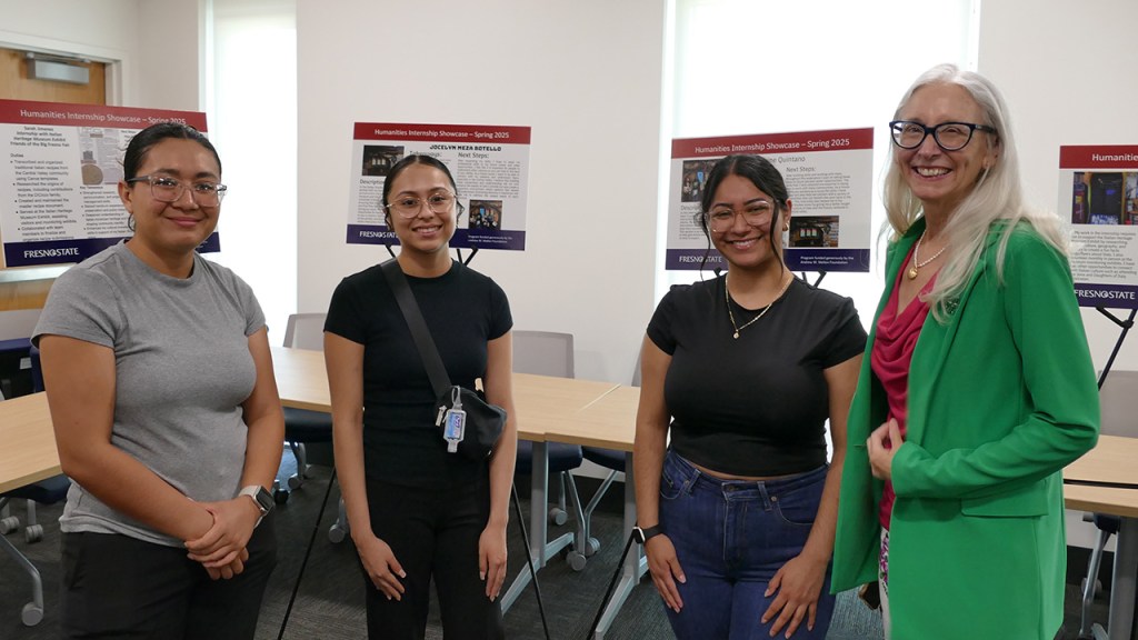 Dr. Honora Chapman, dean of the College of Arts and Humanities, with Department of Modern and Classical Languages and Literatures (MCLL) students and their presentation boards at the Humanities Internship Showcase.